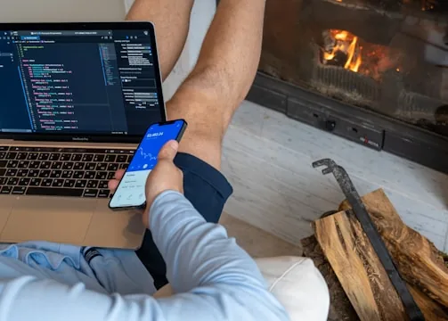 a person sitting in front of a laptop computer